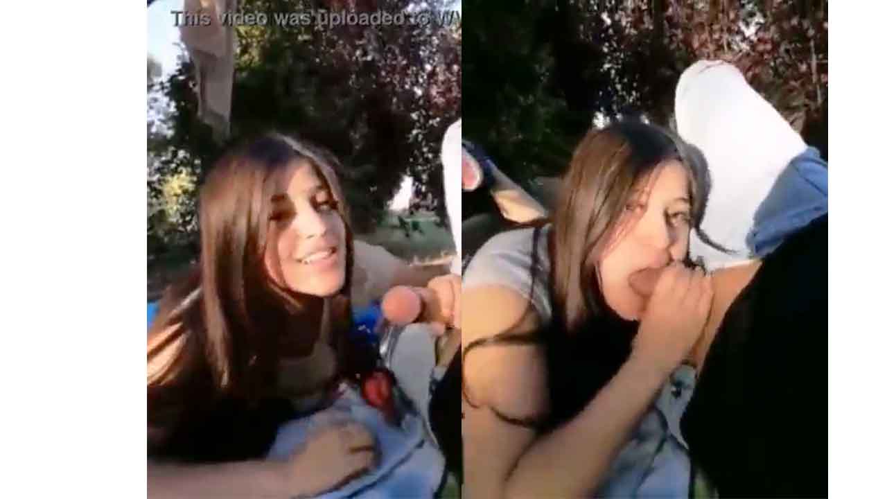 Teen girl sucks her boyfriend's cock in a public park